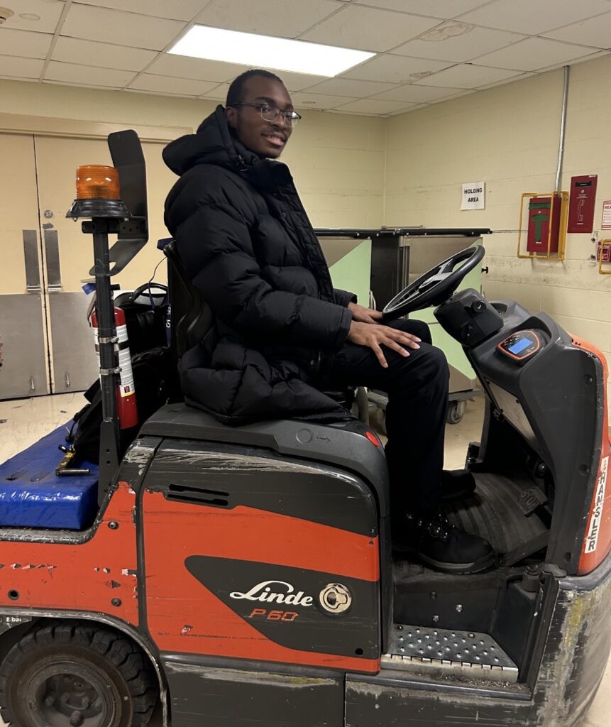Jordan driving a forklift